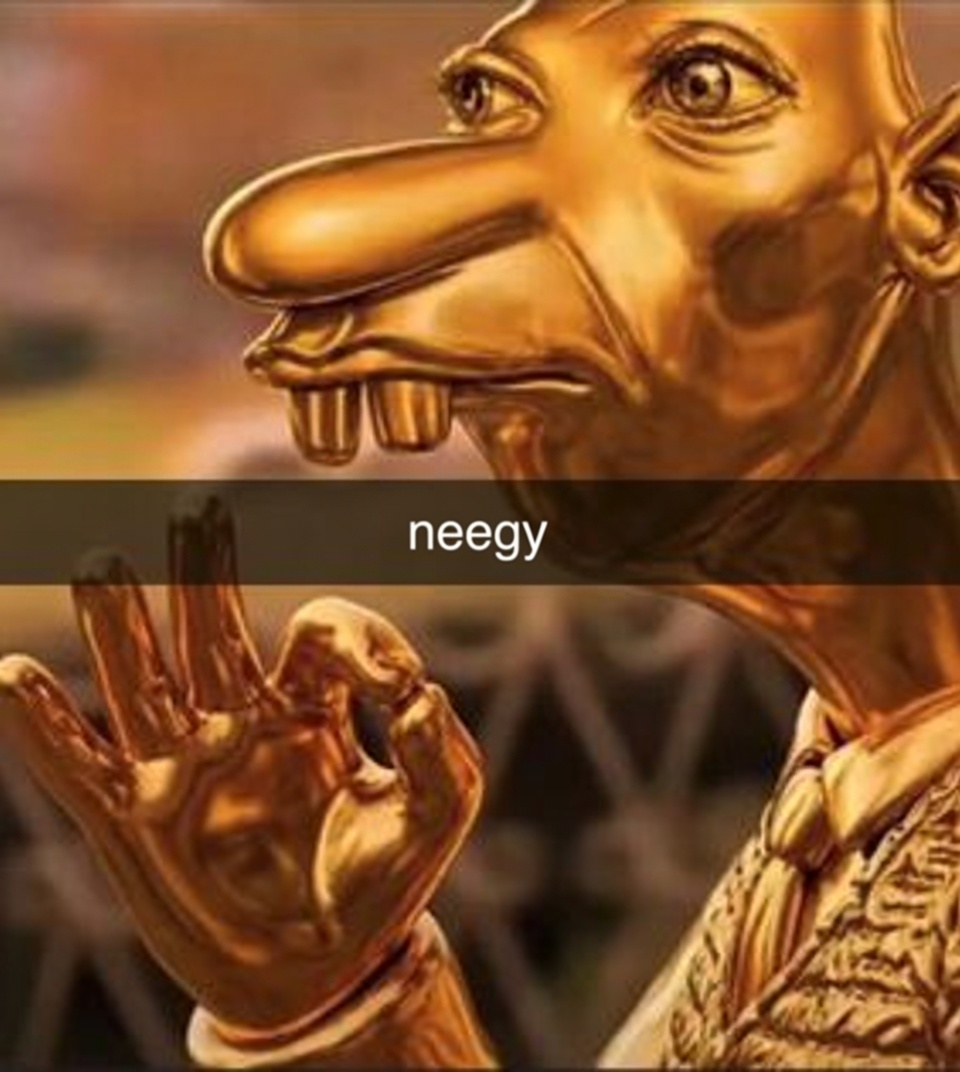 Neegy holding a tiny figure while making an okay hand sign